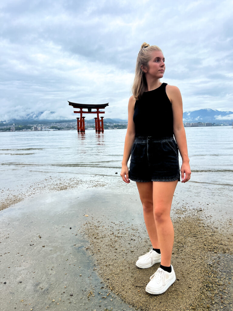 Me standing in front of Itsukushuma Shrine during our 10 day Japan itinerary.