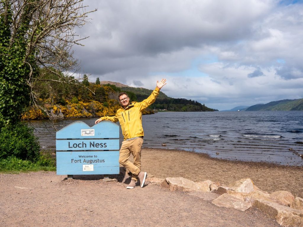 JT infront of a Fort Augustus sign in front of Loch Ness