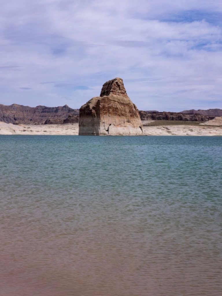 lone rock state beach, a sing rock with blue water underneath it