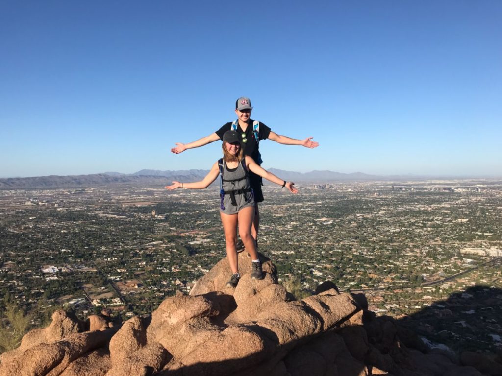 JT and Jordyn standing at the top of camelback mountain on their Arizona Road Trip