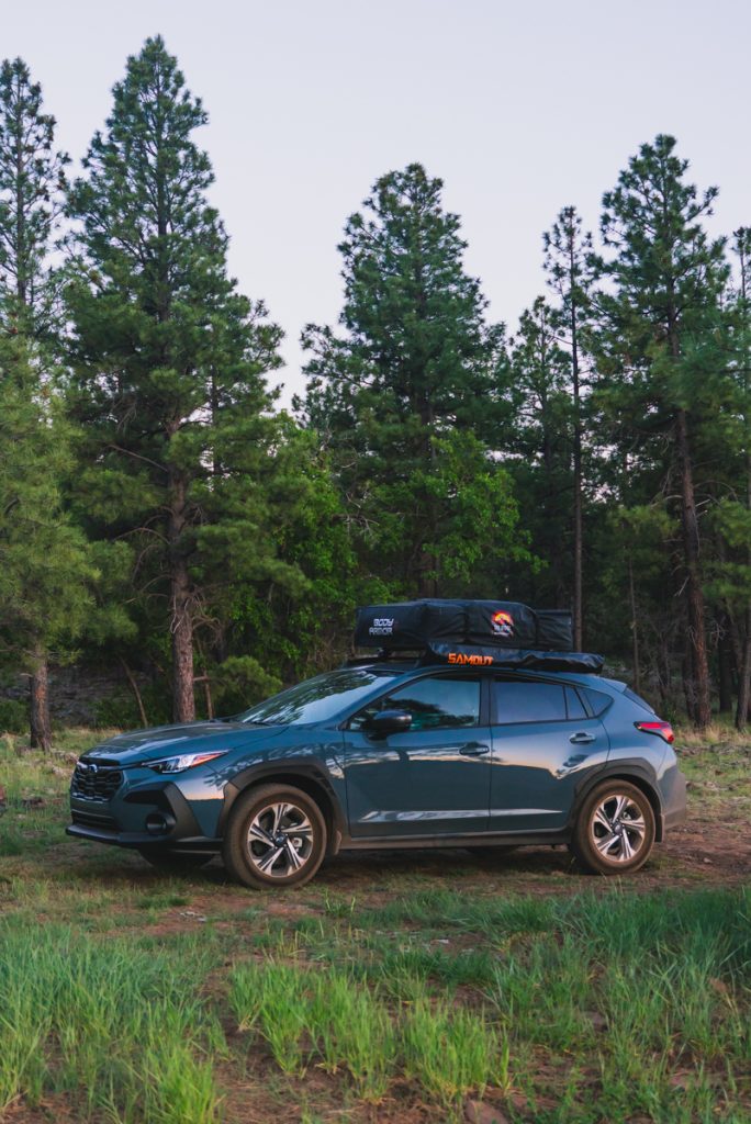 Jordyn and JT's Subaru in the pine forest of Flagstaff, Arizona
