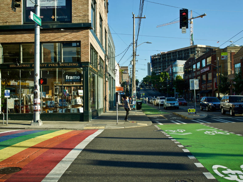 Rainbow crosswalk and bike lane at the corner of Broadway and East Pike in Capitol Hill, a vibrant neighborhood featured in this Seattle travel guide.
