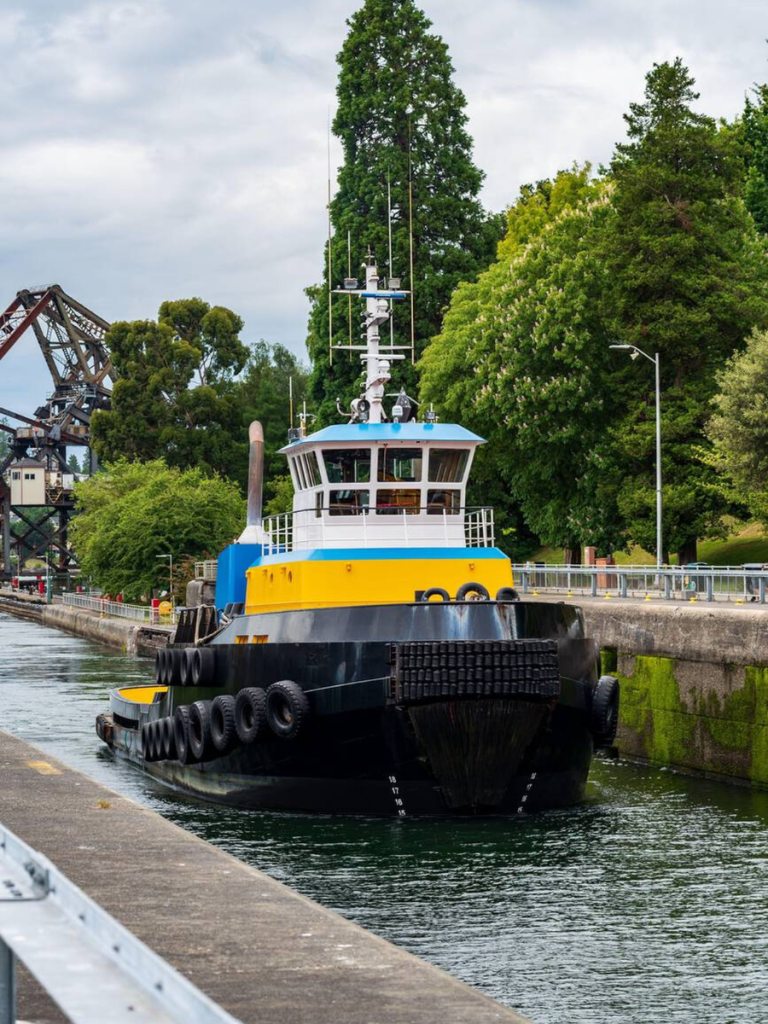 Colorful tugboat passing through the Ballard Locks in Seattle, a popular stop featured in this Seattle travel guide.