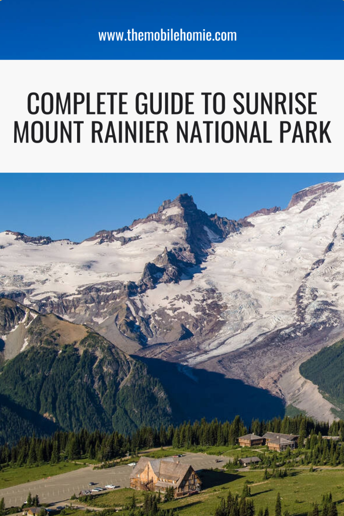 Aerial view of the Sunrise Visitor Center surrounded by alpine meadows with snow-covered Mount Rainier towering in the background at Sunrise Mount Rainier National Park.