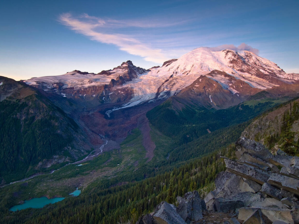 Sunrise lighting up the glaciers on Mount Rainier, seen from a high alpine viewpoint during a Mount Rainier 2 day itinerary.