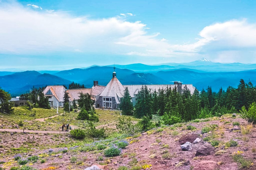 Timberline Lodge perched on Mount Hood with alpine meadows and layered mountain views stretching into the distance, one of the iconic things to see near Portland
