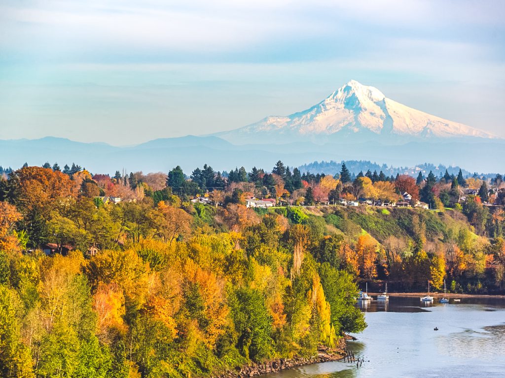 Snow-capped Mount Hood rising above the Willamette River and colorful fall trees in the Portland area