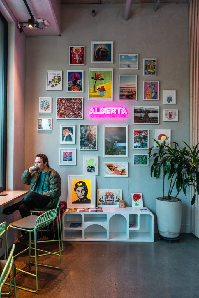 Colorful coffee shop on Alberta Street in Portland with neon sign and local artwork featured in a 3 days in Portland Oregon itinerary