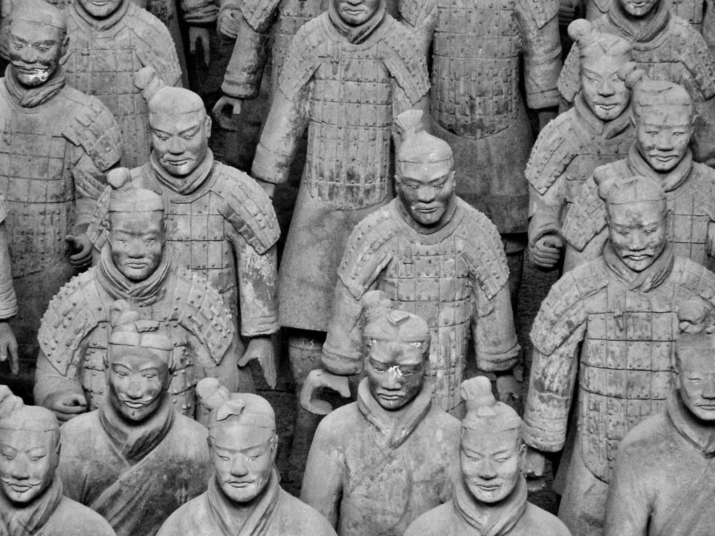 Close-up view of rows of life-sized Terracotta Army soldiers in Xi’an, China, showing detailed armor, facial expressions, and unique features of the ancient clay figures.