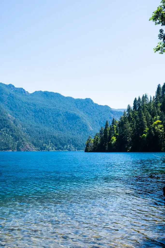 Crystal-clear waters of Lake Crescent surrounded by evergreen forests and mountain peaks in Olympic National Park, Washington.