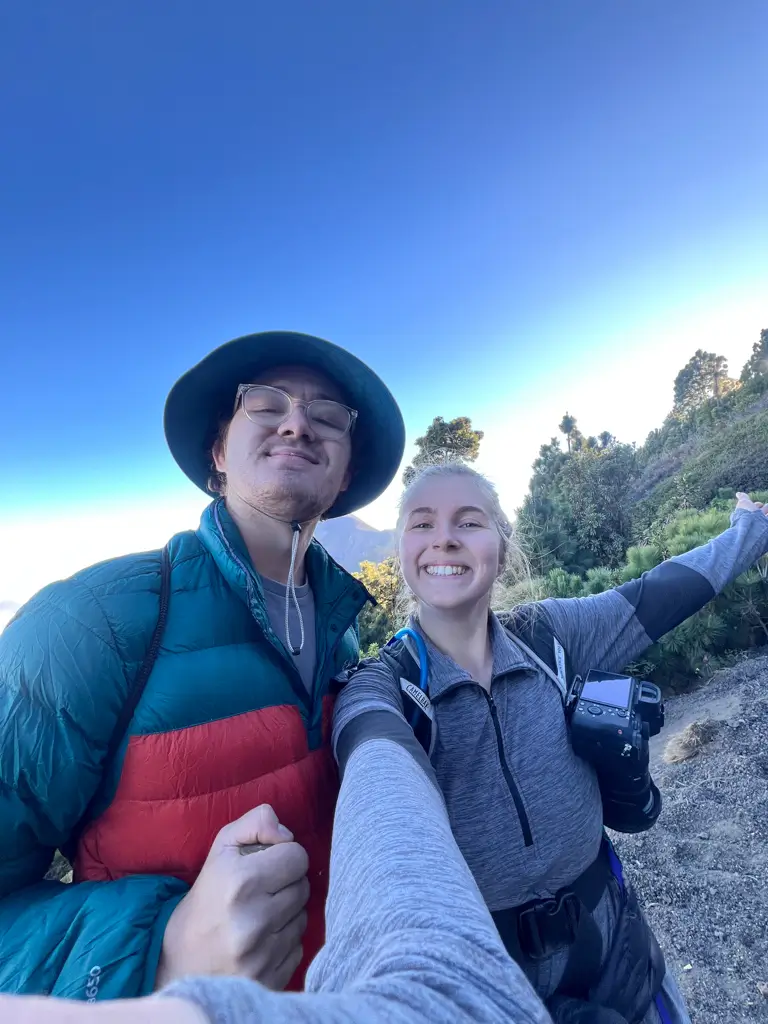 Hikers on the Acatenango Volcano trail in Guatemala using a Peak Design Camera Clip to securely carry a camera while hiking.