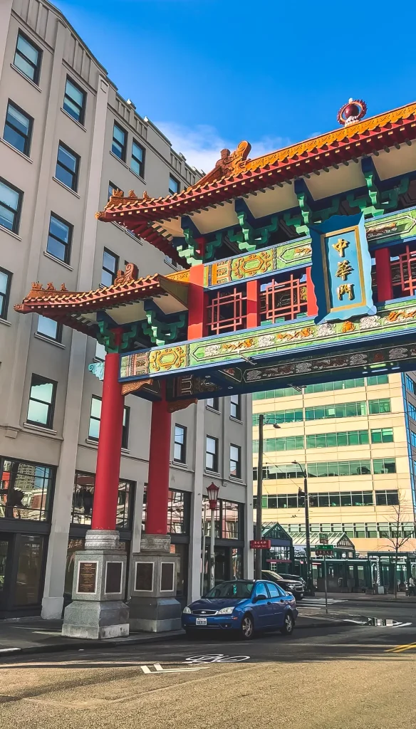 Colorful Chinatown Gate marking the entrance to Seattle’s Chinatown-International District in downtown Seattle, Washington, beneath a bright blue sky.