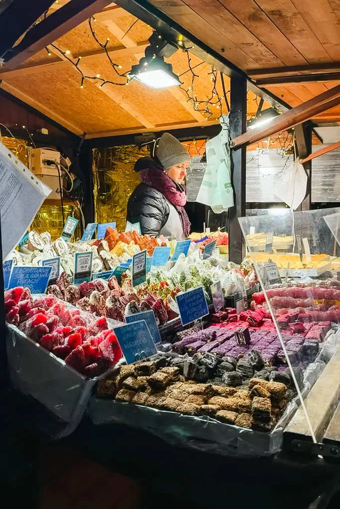 Colorful handmade sweets and confections displayed at a festive food stall at the Wrocław Christmas Market in Poland.